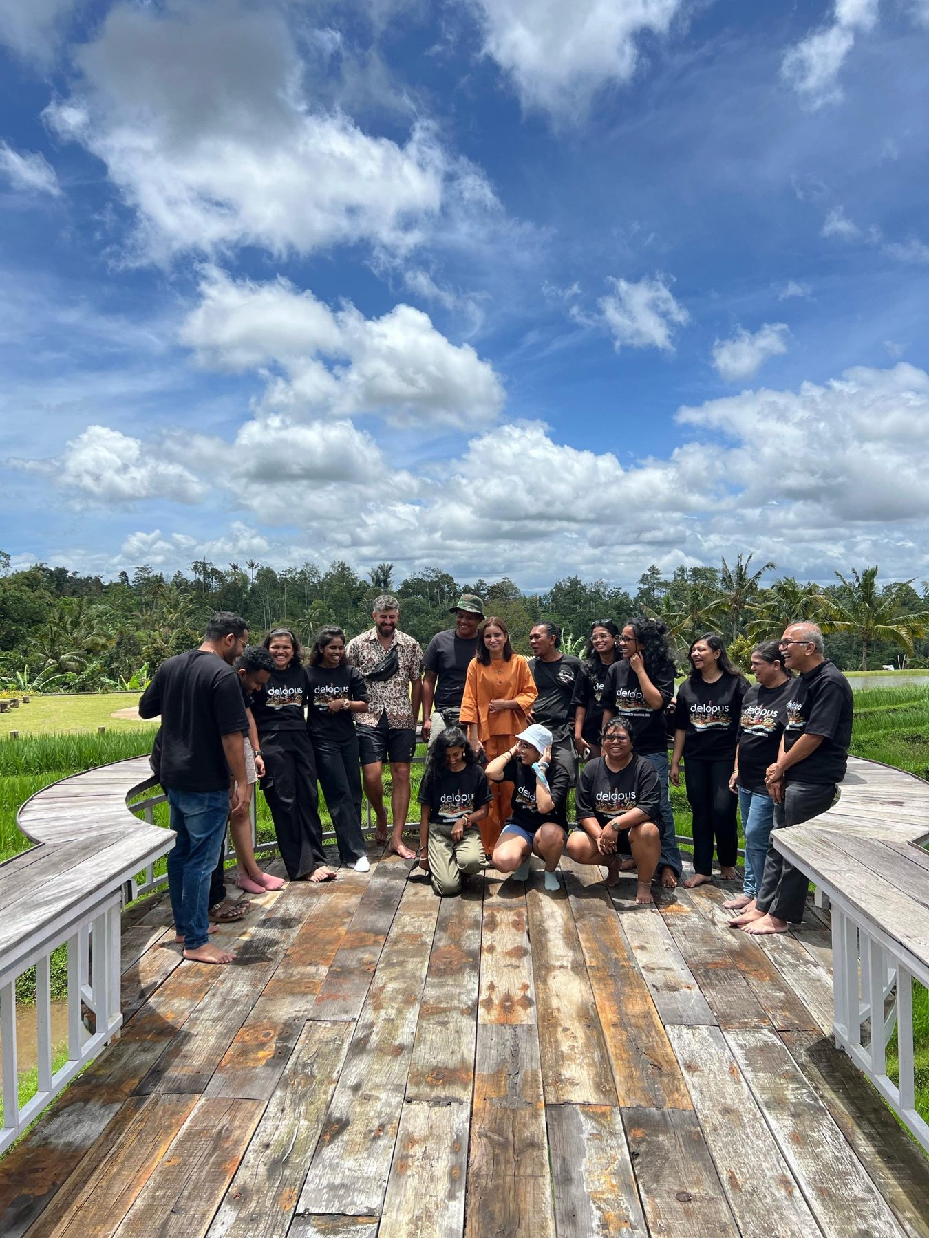 Workshop participants on a wooden deck surrounded by rice fields at Jatiluwih, Bali